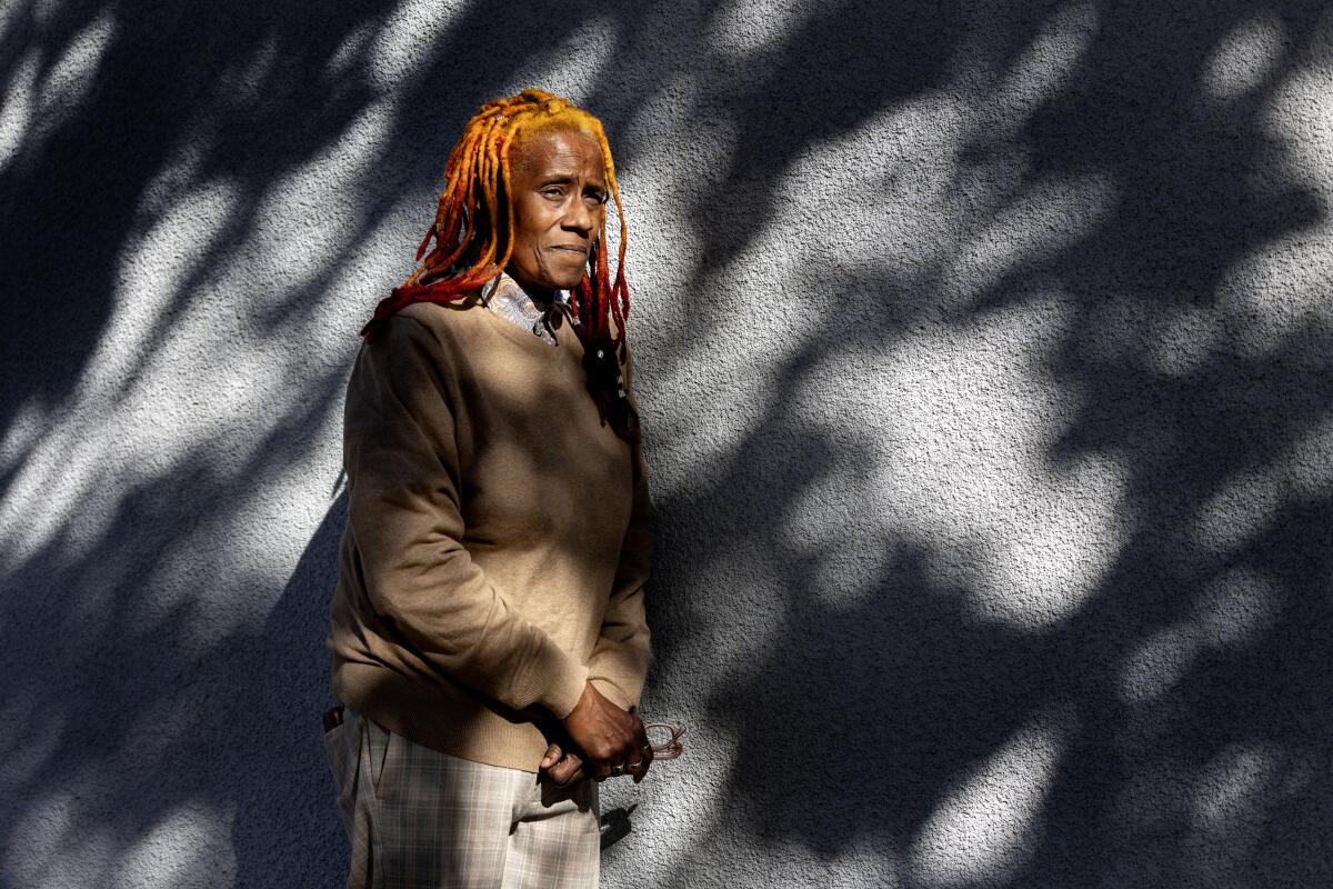 Erica Smith stands outside next to a wall