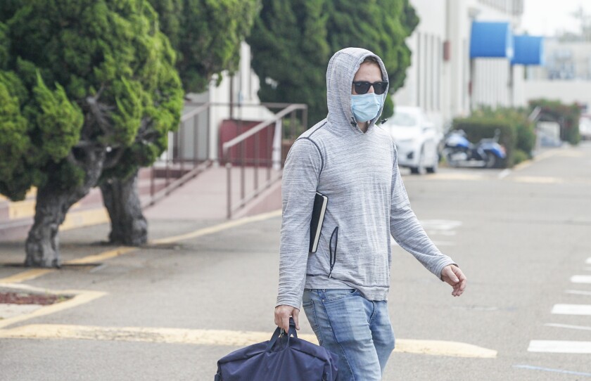 Navy SEAL Adel Enayat, accused of sexual assault, walks across a street after appearing for a hearing at Naval Base San Diego