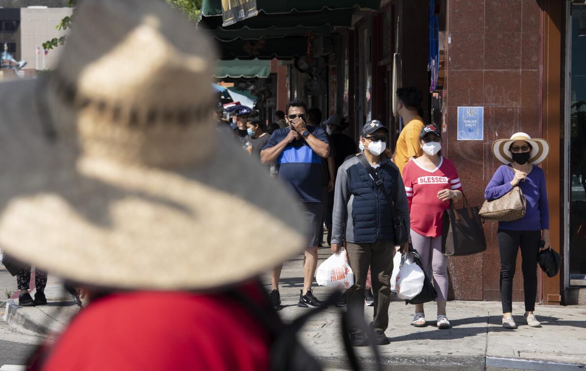 Visitors to Chinatown wear masks