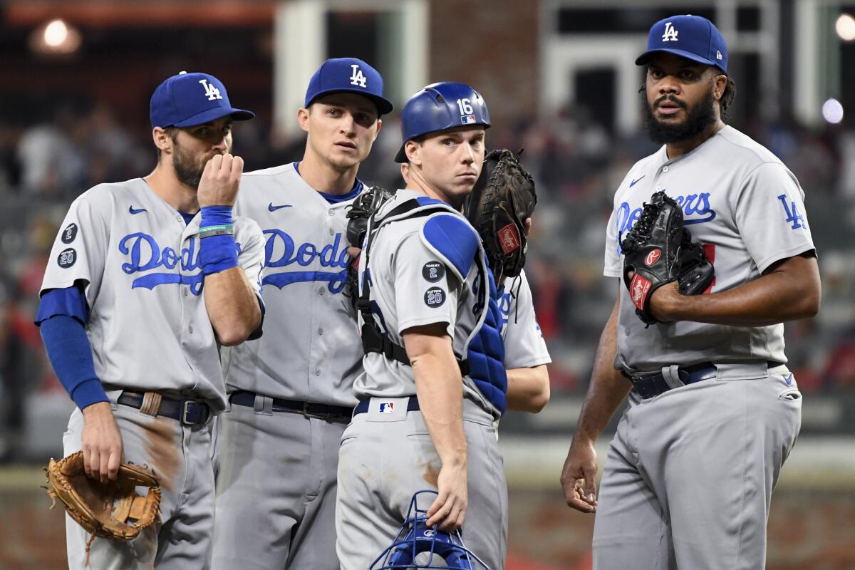 Dodgers players Chris Taylor, Corey Seager, Will Smith and Kenley Jansen talk on the mound.