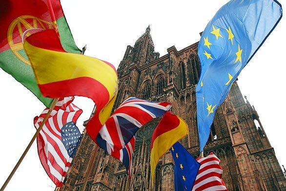 International flags fly in front of the Strasbourg Cathedral in Strasbourg, France. NATO's's 60th anniversary summit will take place in Strasbourg and Baden-Baden, Germany, April 3-4.