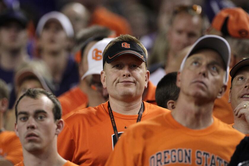 FILE - Dejected Oregon State fans during an NCAA college football game against TCU.
