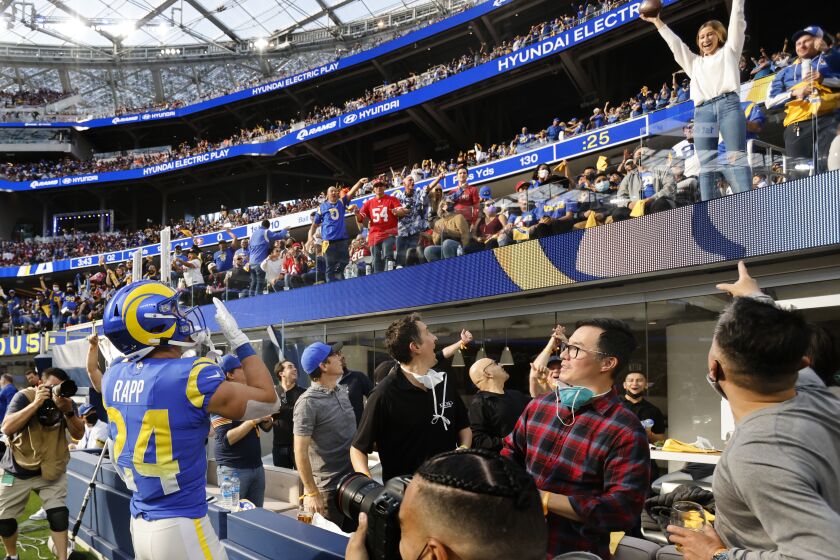 INGLEWOOD, CA - JANUARY 9, 2022: Los Angeles Rams free safety Taylor Rapp (24) tosses the ball to a fan after an interception against the 49ers in the first half on January 9, 2022 at SoFi Stadium in Inglewood, California.(Gina Ferazzi / Los Angeles Times)