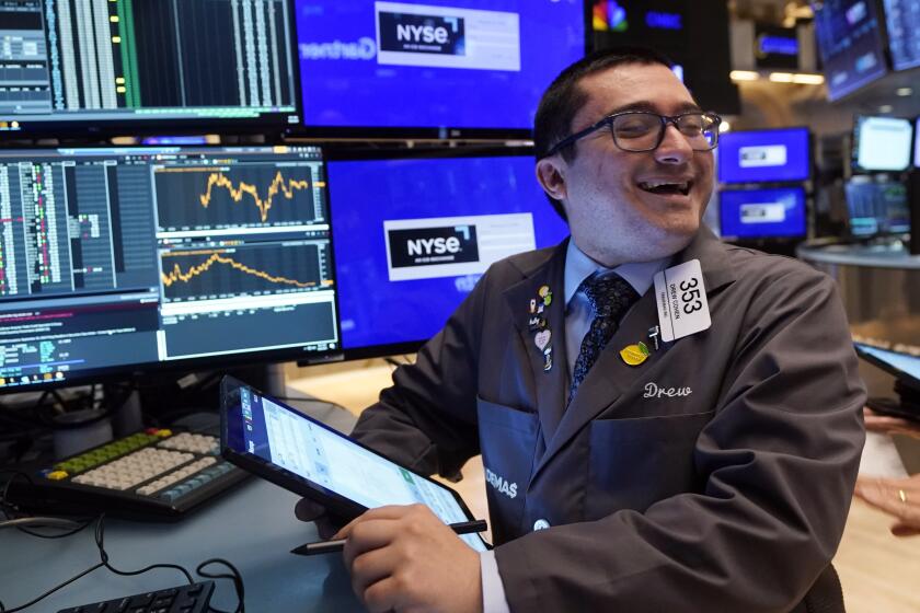 Trader Drew Cohen works on the floor of the New York Stock Exchange, Tuesday, Aug. 6, 2024.(AP Photo/Richard Drew)