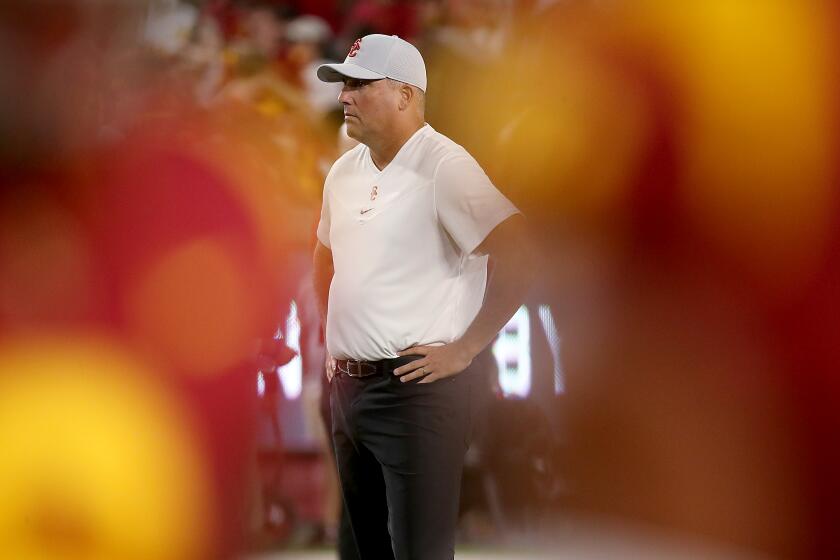 LOS ANGELES, CALIF. - SEP 11, 2021. USC head coach Clay Helton watches the Trojans warm up before a game against Stanford at the Coliseum on Saturday night, Sep. 11, 2021. (Luis Sinco / Los Angeles Times)