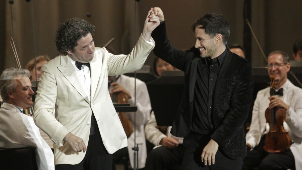 Gustavo Dudamel, left, gives a nod to Gael García Bernal after the actor’s “guest conducting” in a performance at the Bowl.