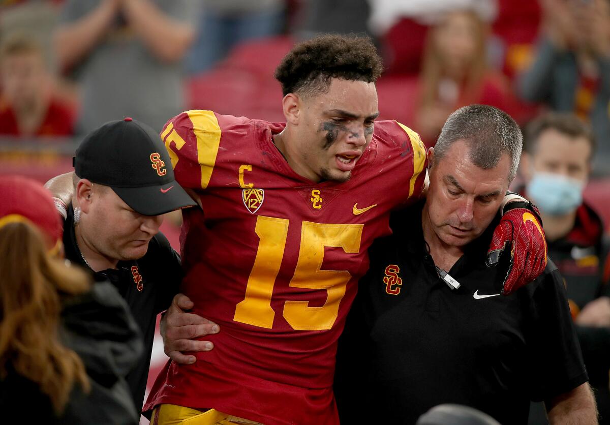 USC wide receiver Drake London is helped off the field after getting injured on a second-quarter touchdown Oct. 30, 2021.