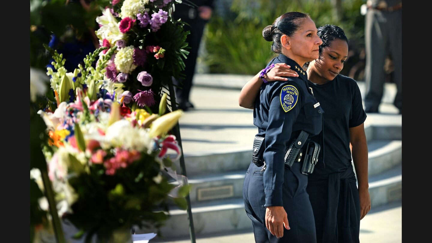 Manhattan Beach Police Chief Eve Irvine, left, consoles police employee Sayeh Kahn after a news conference about the death of police records technician Rachael Parker in the Las Vegas shooting.