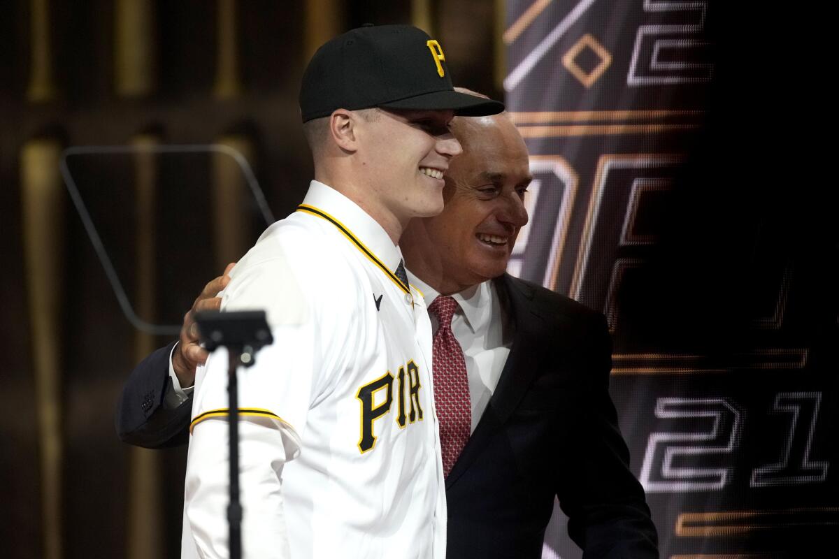 Louisville's Henry Davis stands with MLB Commissioner Rob Manfred after being selected by Pittsburgh Pirates as the number one overall pick in the first round of the 2021 MLB baseball draft, Sunday, July 11, 2021, in Denver. (AP Photo/David Zalubowski)
