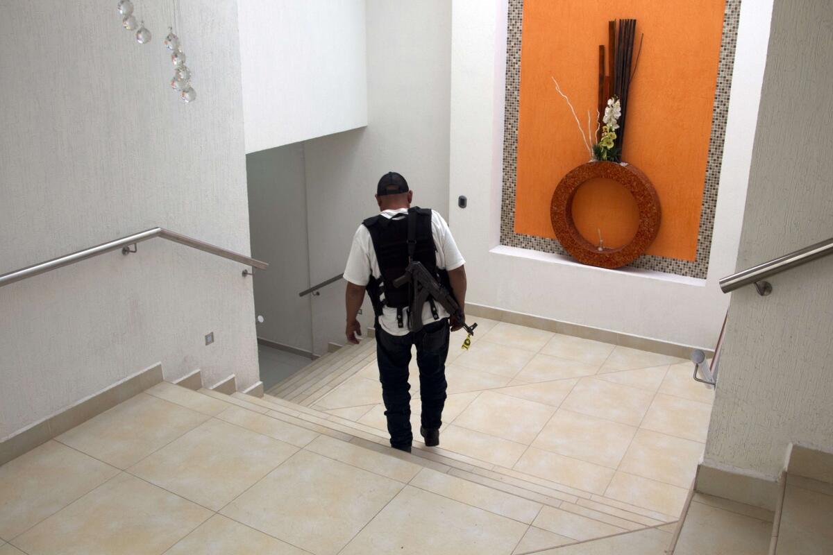 An armed member of the Self Protection militia is seen inside the house of drug trafficker Enrique Plancarte aka "Quique Plancarte" in Nueva Italia, state of Michoacan, Mexico, on January 17, 2014. The house was taken by members of the Self-Protection militias. AFP PHOTO/Hector GuerreroHECTOR GUERRERO/AFP/Getty Images ** OUTS - ELSENT, FPG, TCN - OUTS * NM, PH, VA if sourced by CT, LA or MoD **