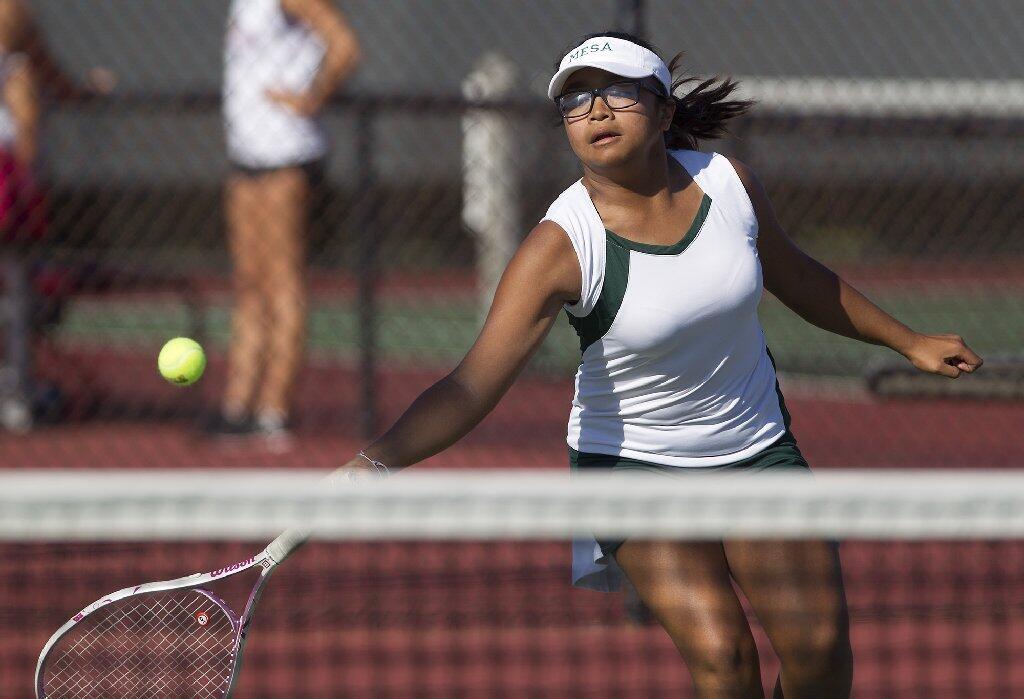 Costa Mesa High's Nancy Le gets under the ball during a No. 1 singles set against Estancia.