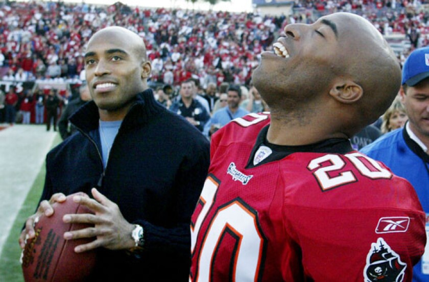 Tampa Bay cornerback Ronde Barber (20) celebrates a 31¿6 victory over the San Francisco 49ers with twin brother and former New York Giants running back Tiki Barber.