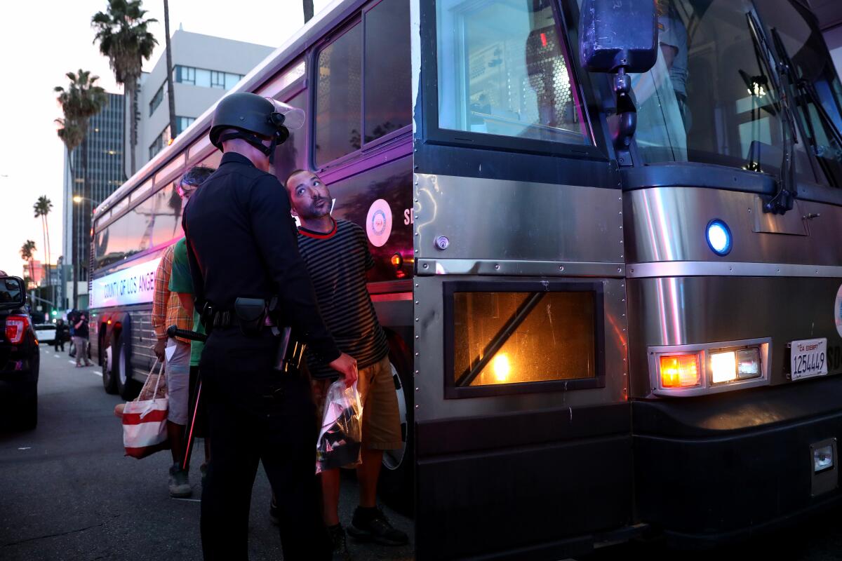 Arrested protesters loaded onto a police bus