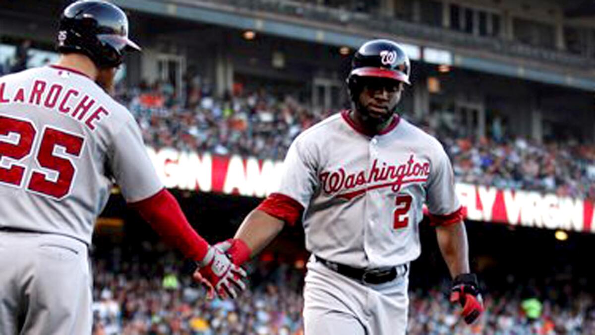 Denard Span (2) in congratulated by Nationals teammate Adam LaRoche (25) after scoring against the Giants during a game in San Francisco on June 9, 2014.