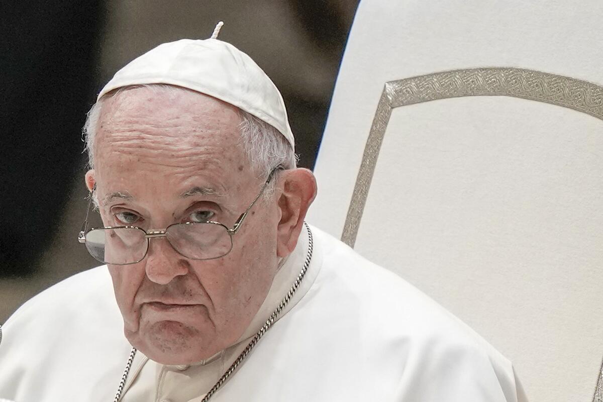 Pope Francis peers over his glasses. 