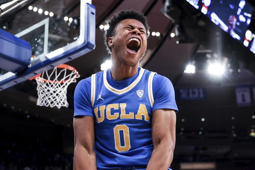 UCLA guard Jaylen Clark reacts after a slam dunk during the second half of an NCAA college basketball game.