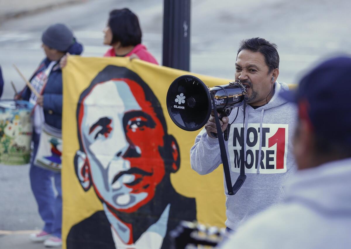 Tomas Martinez shouts into a bullhorn during an immigration reform rally Friday in Atlanta.