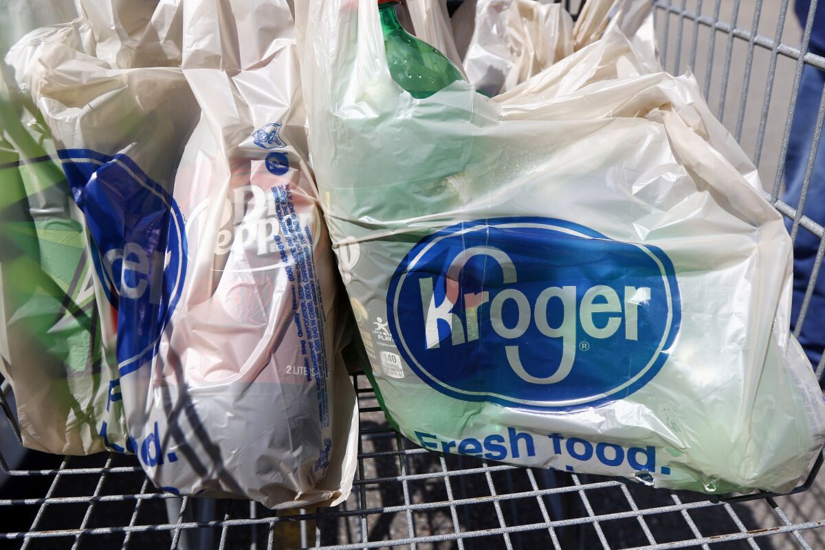 FILE - In this June 15, 2017, file photo, bagged purchases from the Kroger grocery store in Flowood, Miss., sit inside this shopping cart. Kroger is teaming up with Instacart on a new delivery service that can get grocery items to customers in as few as 30 minutes. The announcement comes at a time when many people are having groceries delivered for convenience and want their items to arrive quickly. Kroger Co. said Tuesday, Sept. 14, 2021 that the service, called Kroger Delivery Now, will offer 25,000 items and reach up to 50 million homes. (AP Photo/Rogelio V. Solis, File)
