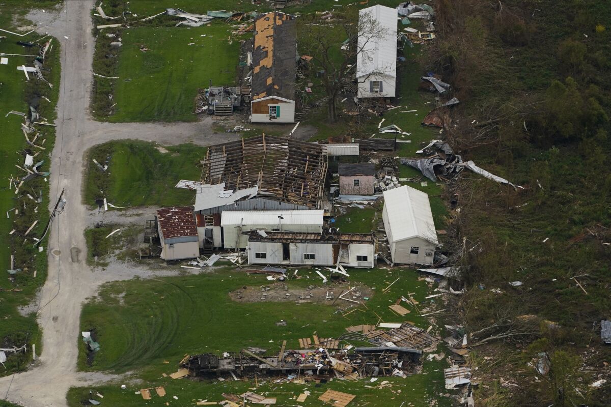 FILE - In this aerial photo, the remains of destroyed homes are seen in the aftermath of Hurricane Ida, Sept. 6, 2021, in Lafitte, La. Damage wrought by Hurricane Ida in the U.S. state of Louisiana and the flash floods that hit Europe last summer have helped make 2021 one of the most expensive years for natural disasters. Reinsurance company Munich Re said Monday, Jan. 10, 2022 that overall economic losses from natural disasters worldwide last year reached $280 billion. (AP Photo/Matt Slocum, file)