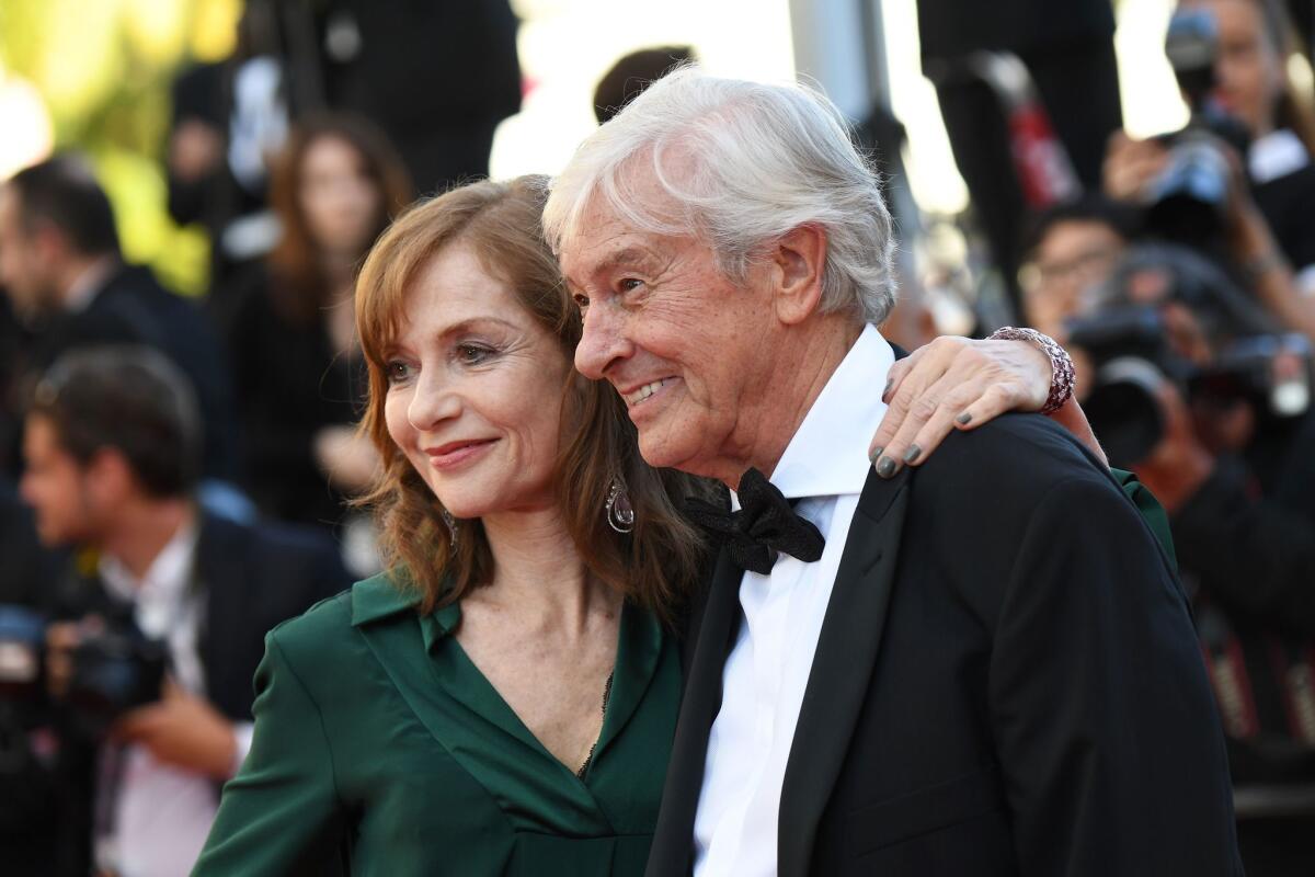 French actress Isabelle Huppert and Dutch director Paul Verhoeven arrive for the screening of "Elle" at Cannes.