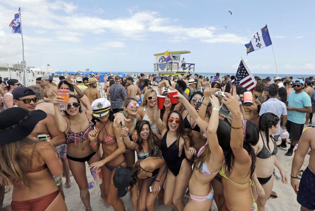 FILE - College students have fun during their spring break in the South Beach area of Miami Beach, Fla., March 14, 2016. Miami Beach officials can move forward with plans to end alcohol sales after 2 a.m. in certain parts of South Beach, an internationally famous tourist spot, according to a ruling handed down Tuesday, March 14, 2023. (AP Photo/Alan Diaz, File)