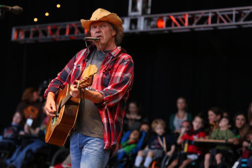 Neil Young, at the 2012 Bridge School Benefit in Northern California, will respond to fans' questions on Twitter on Oct. 24.