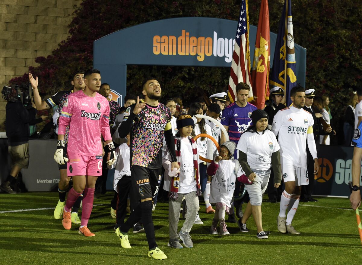 San Diego Loyal and Las Vegas Lights players come onto the field before their soccer game last March at Torero Stadium