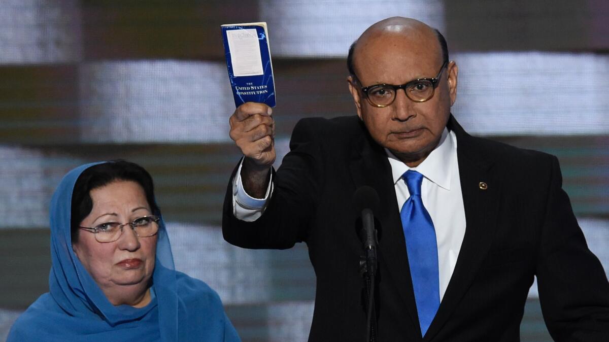 Khizr Khan, with his wife, Ghazala Khan, holds his personal copy of the U.S. Constitution during an appearance at the Democratic National Convention.