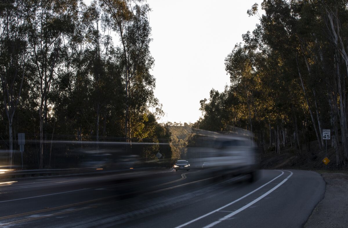 Vehicles blur as they drive along Pomerado Road near Semillon Boulevard on Thursday, Feb. 10 in San Diego. 
