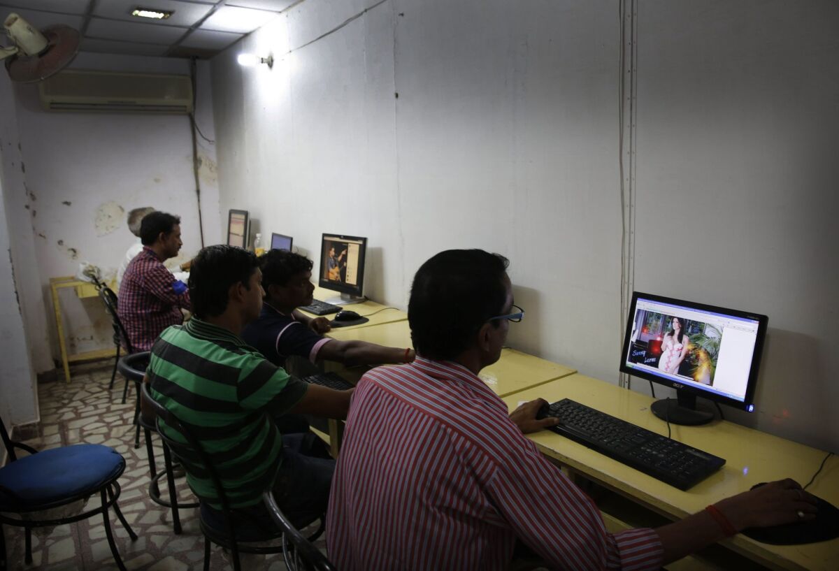 Indian youth use the Internet at a cyber cafe in Allahabad, India, on Monday.