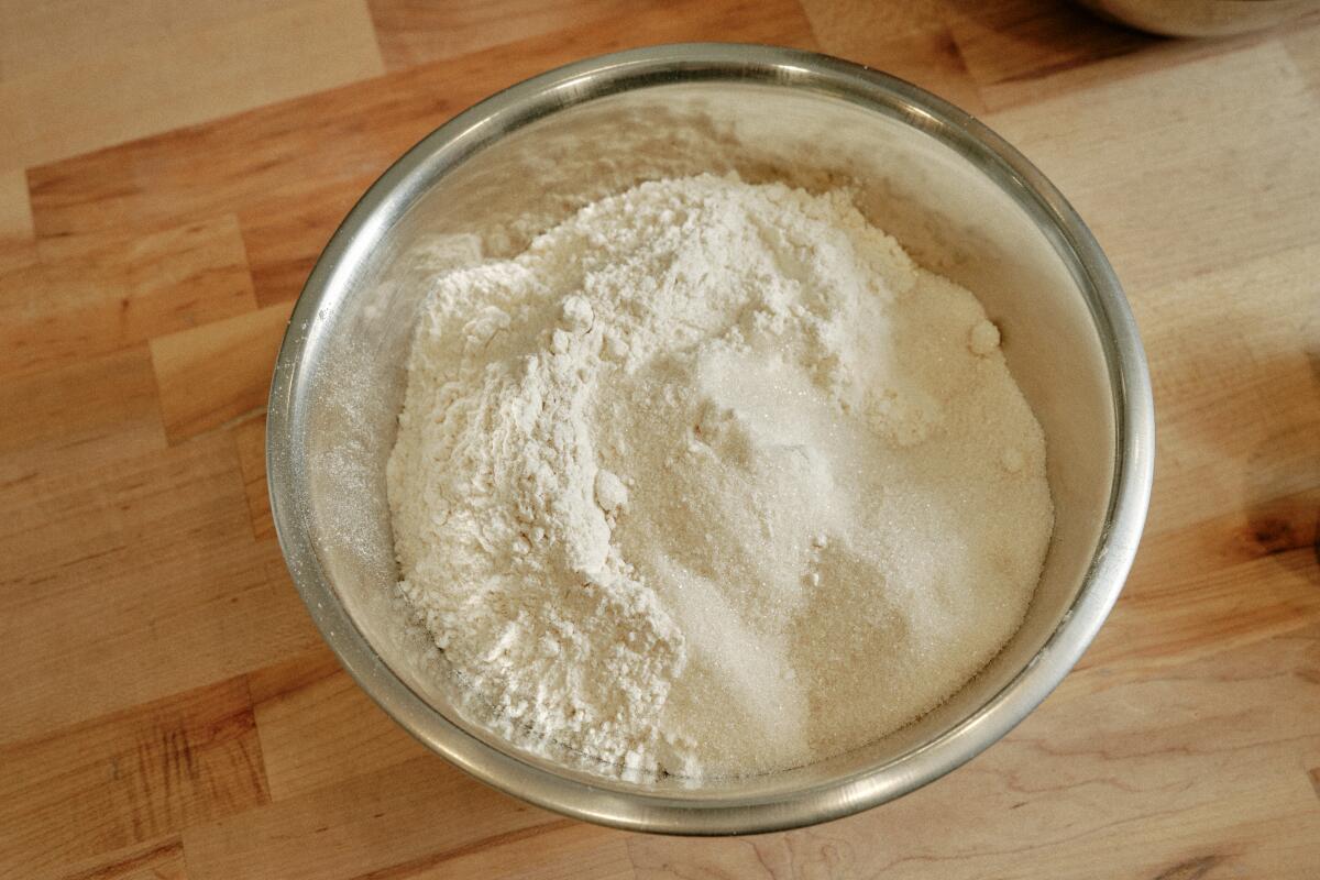  A bowl of flour and sugar that will go into making the dough for pan de muerto at Gusto Bread.