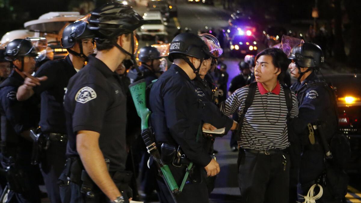 Police detain a protester Friday near Alvarado and Beverly. Hundreds of people have been arrested in Los Angeles this week after a grand jury decision in a fatal police shooting in Ferguson, Mo.