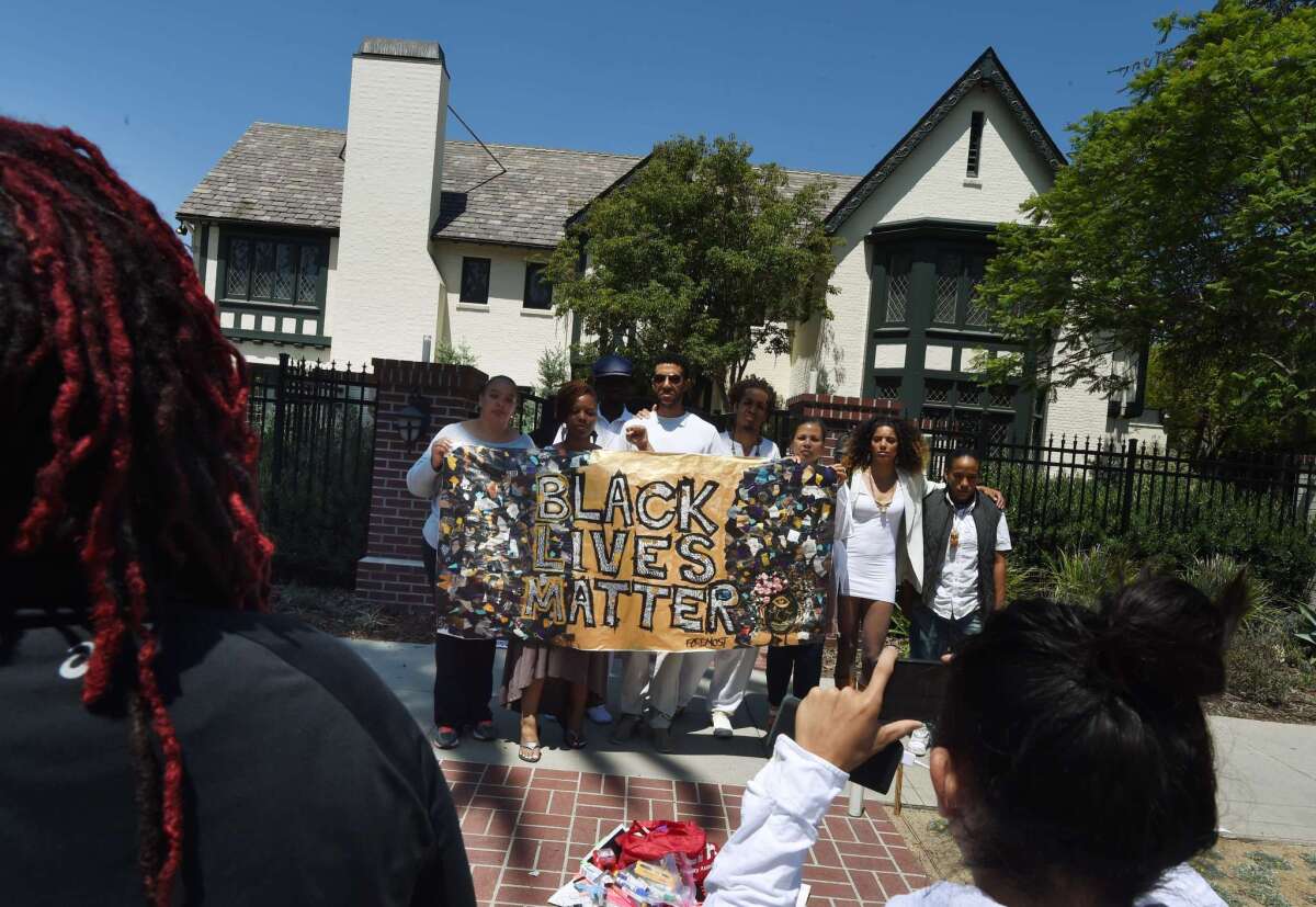 Members of the "Black Lives Matter" alliance protest outside Mayor Eric Garcetti's home on June 7 as they call on him to fire LAPD Chief Charlie Beck.