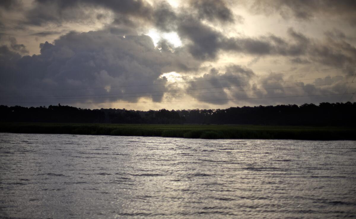 The sun rises on a cloudy day over Sapelo Island