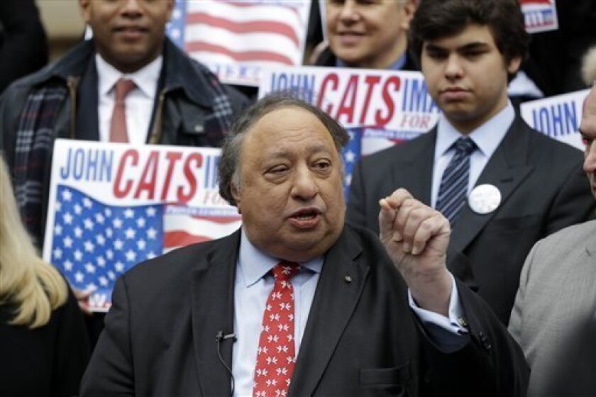 Surrounded by supporters, John Catsimatidis talks to the media during a news conference on the steps of City Hall in New York, Tuesday, Jan. 29, 2013. Catsimatidis announced his intention to run for New York City mayor. (AP Photo/Seth Wenig)