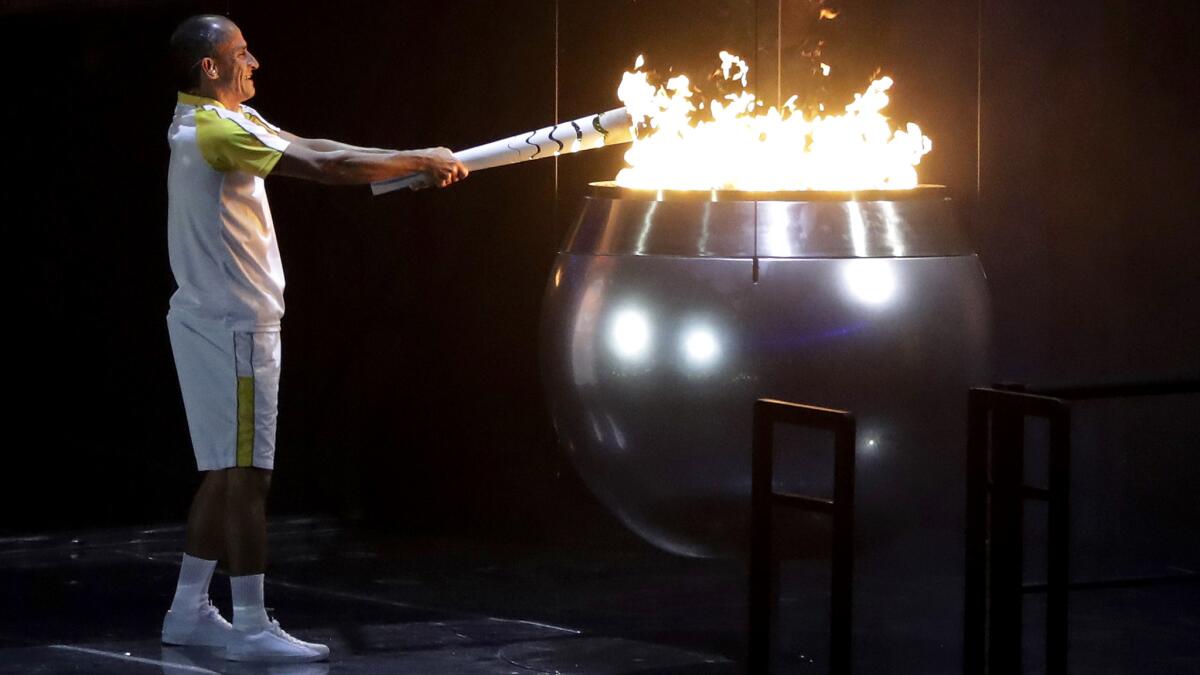 Vanderlei de Lima lights the Olympic flame during the opening ceremony Friday night in Rio de Janeiro. (Jae C. Hong / Associated Press)