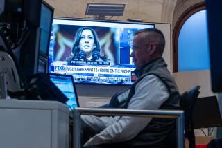 NEW YORK, NEW YORK - JULY 22: Traders work on the floor of the New York Stock Exchange (NYSE) as a picture of Vice President Kamala Harris is displayed on a television screen on July 22, 2024 in New York City. Markets were up in morning trading as the world reacted to the news that U.S. President Joe Biden has ended his re-election campaign and endorsed Vice President Kamala Harris. (Photo by Spencer Platt/Getty Images)