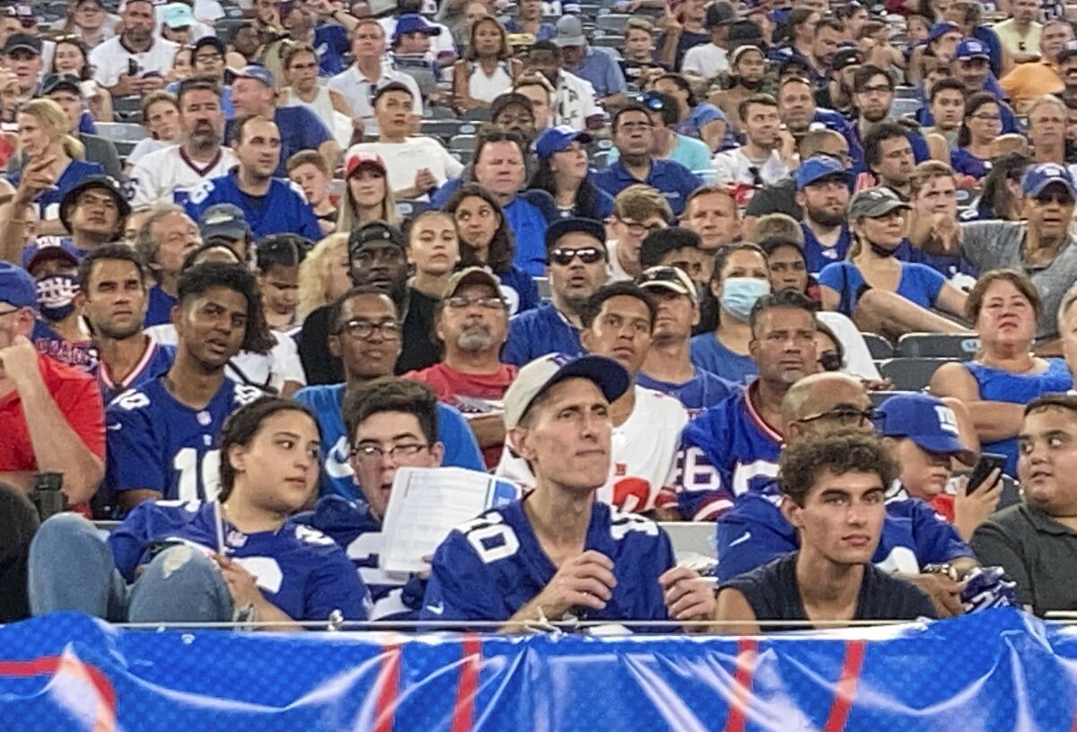 Fans attend the New York Giants' NFL football practice at MetLife Stadium on Wednesday, Aug. 11, 2021, in East Rutherford, N.J. (AP Photo/Tom Canavan)