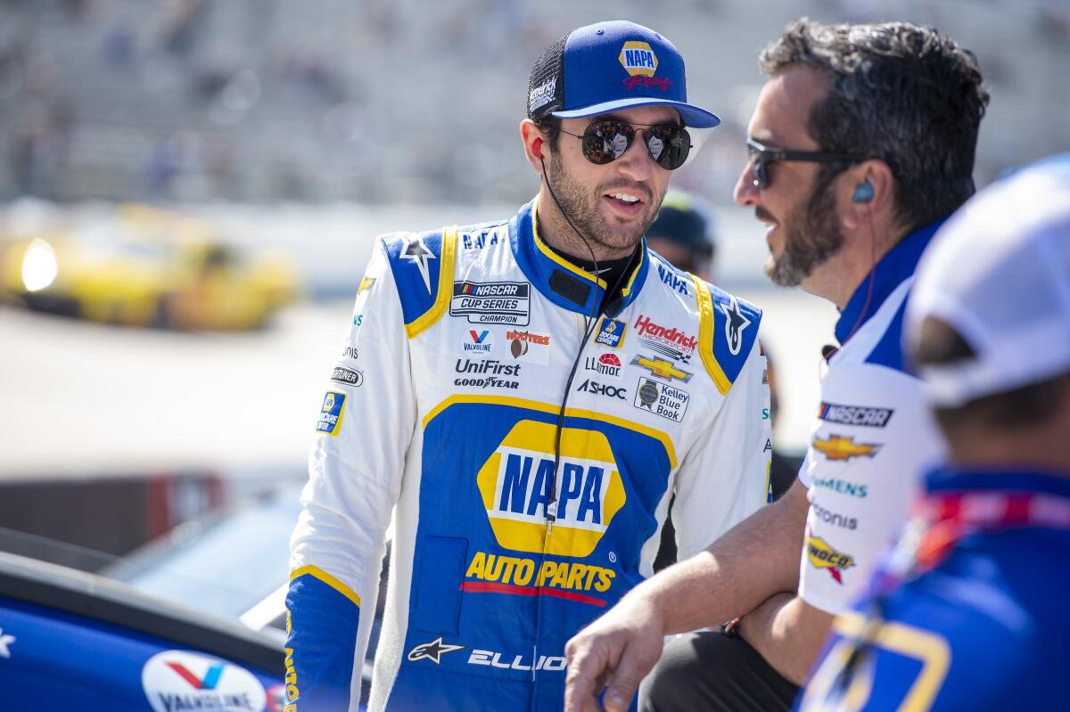 Chase Elliott talks with his team during NASCAR Cup practice at Dover Motor Speedway on April 30.