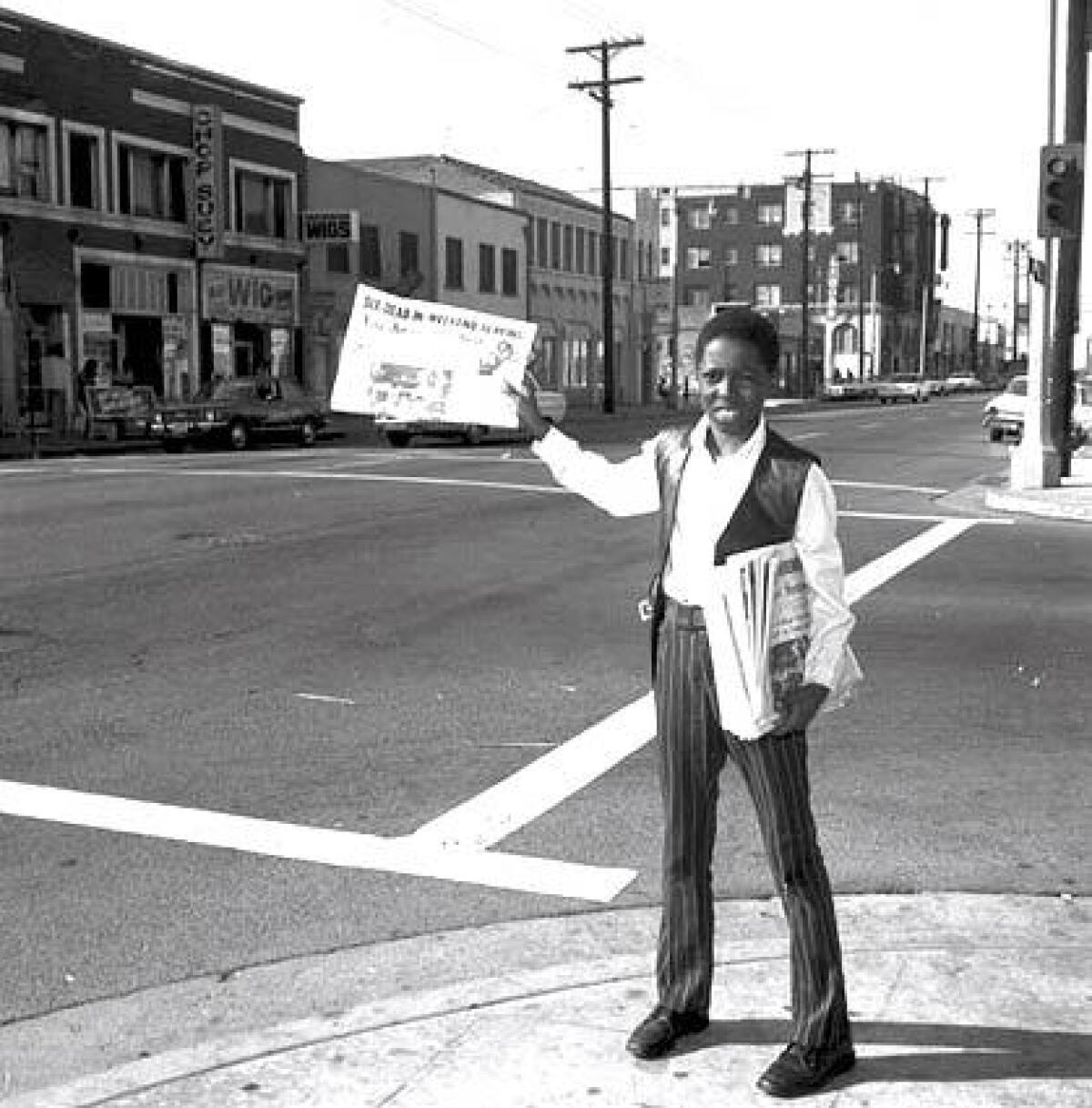A news vendor in 1964 sells the Los Angeles Sentinel, one of the largest Black newspapers in Southern California.