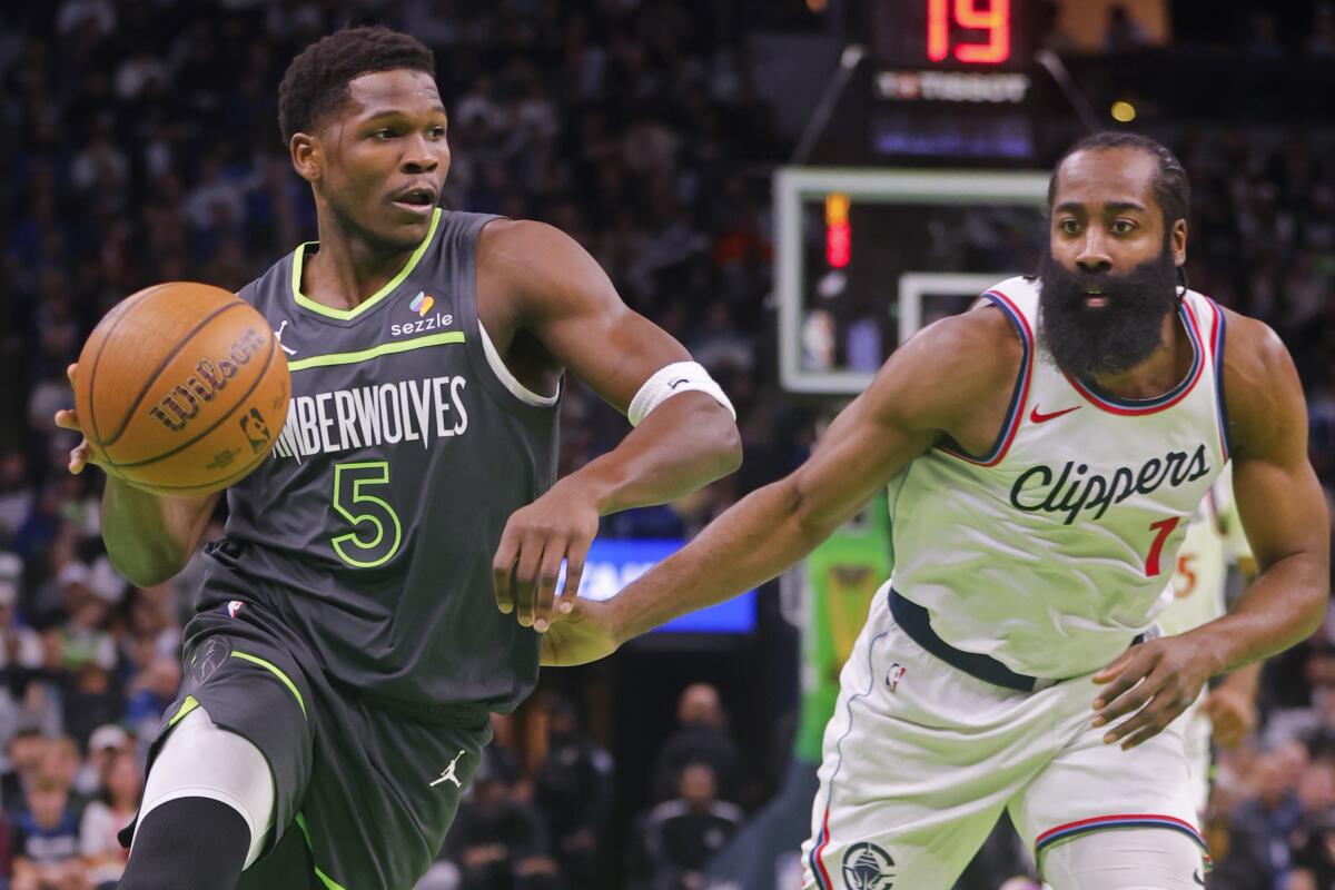 Timberwolves guard Anthony Edwards, left, drives around Clippers guard James Harden in the first quarter Friday.