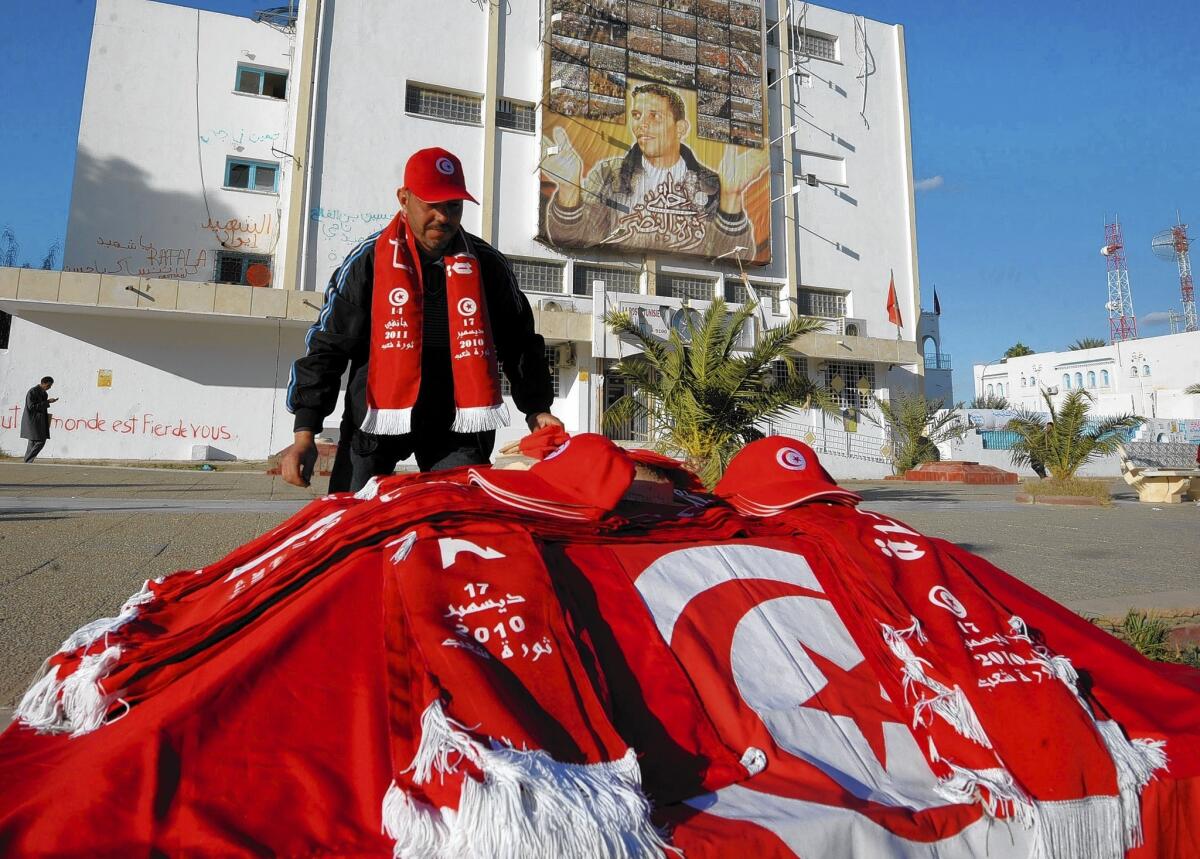 A Tunisian vendor sells national flags and caps along Mohammed Bouazizi Avenue in the impoverished town of Sidi Bouzid where the self-immolation of a 26-year-old street vendor three years ago led to the uprising that forced veteran president Zine El Abidine Ben Ali to flee the country.
