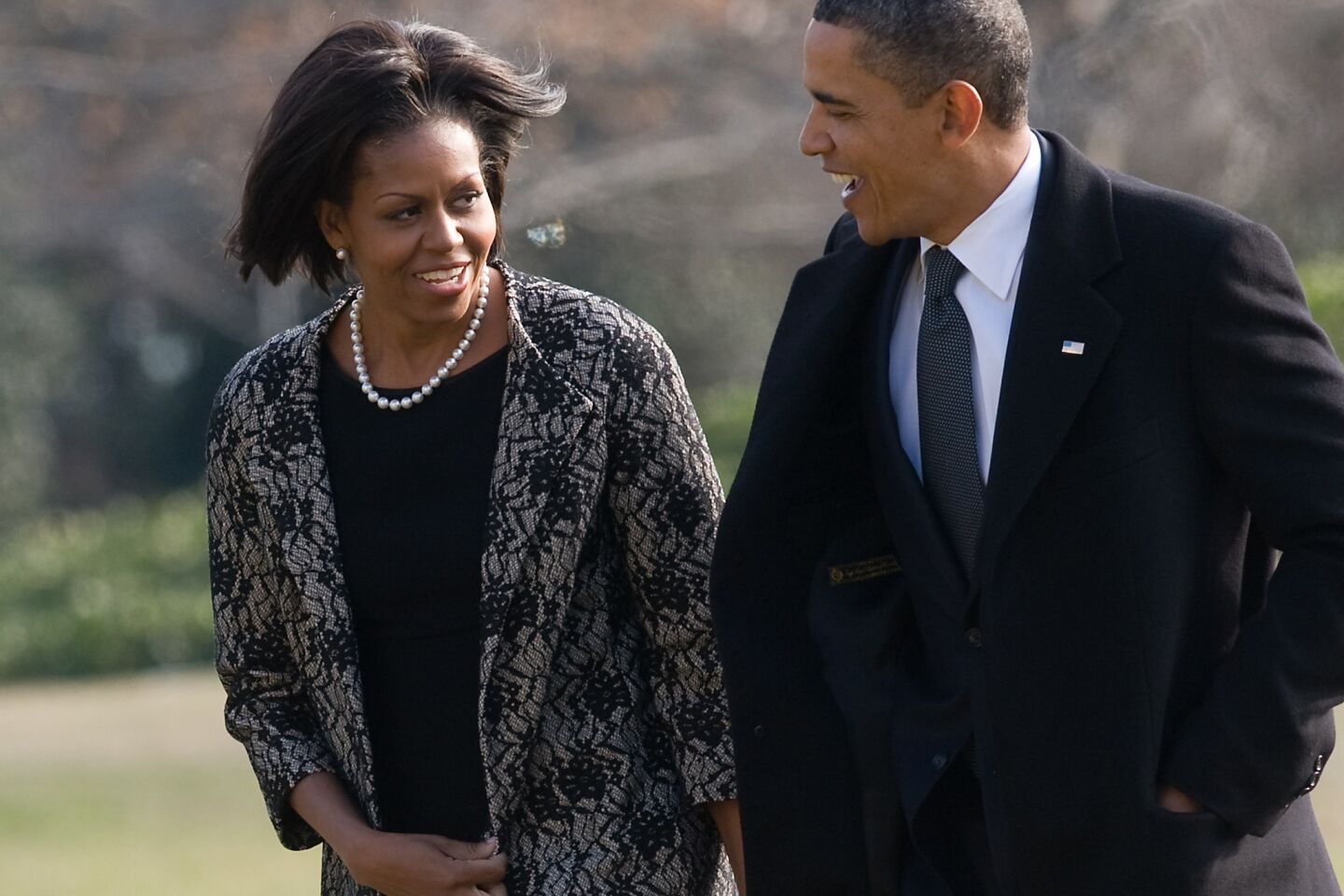 First Lady Michelle Obama, with President Obama, is dressed in traditional somber attire for the funeral of Vice President Joe Biden's mother in 2010, but she also shows off a new bobbed hairstyle.