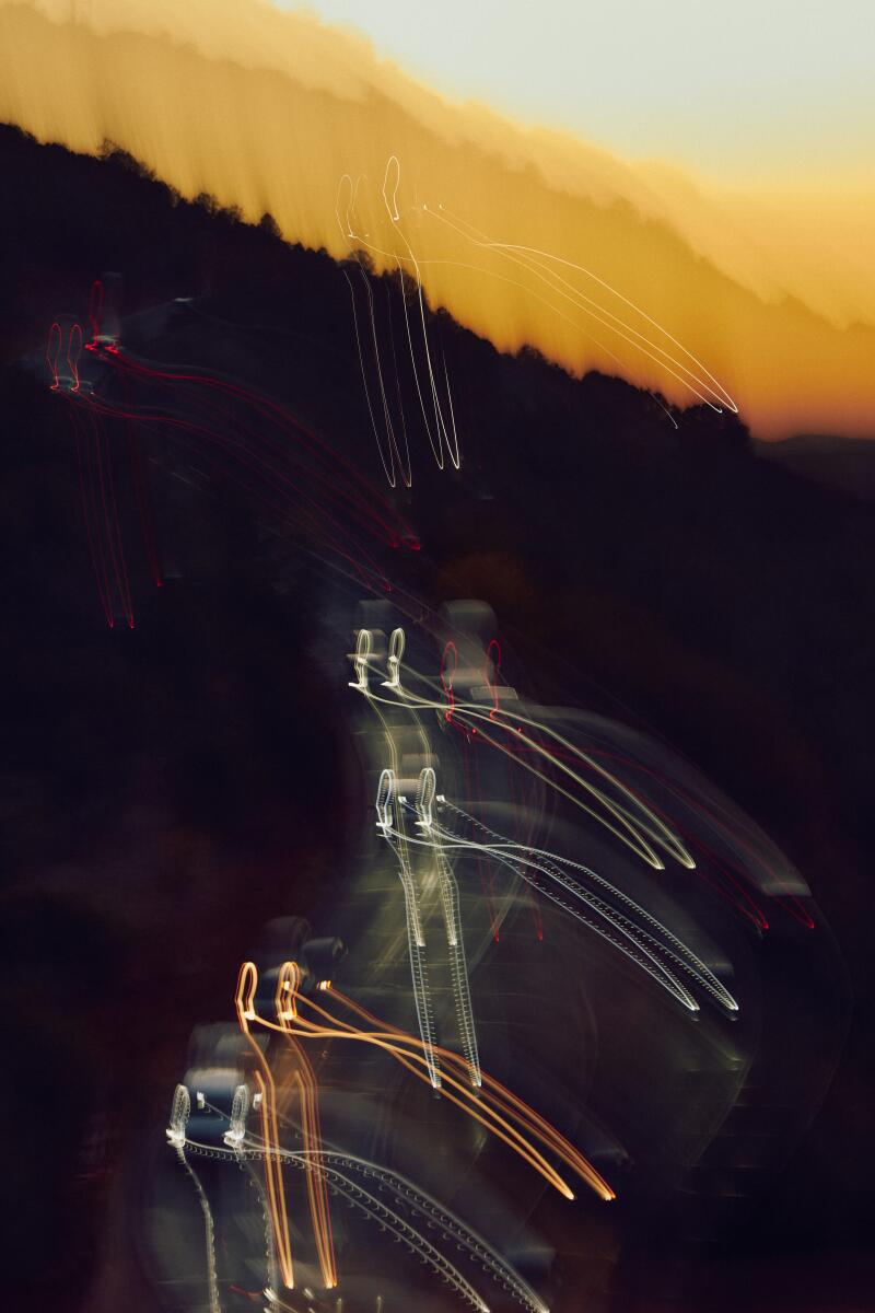 Car lights bounce in the distance in a long exposure photo taken Airport Loop Trail in Sedona.