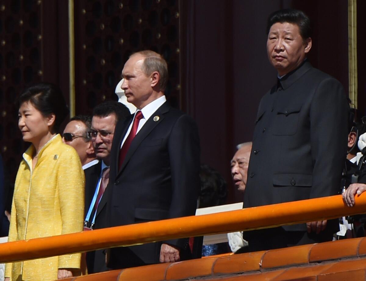 Chinese President Xi Jinping, right, stands with Russian President Vladimir Putin and South Korean President Park Geun-hye at a military parade in Beijing.