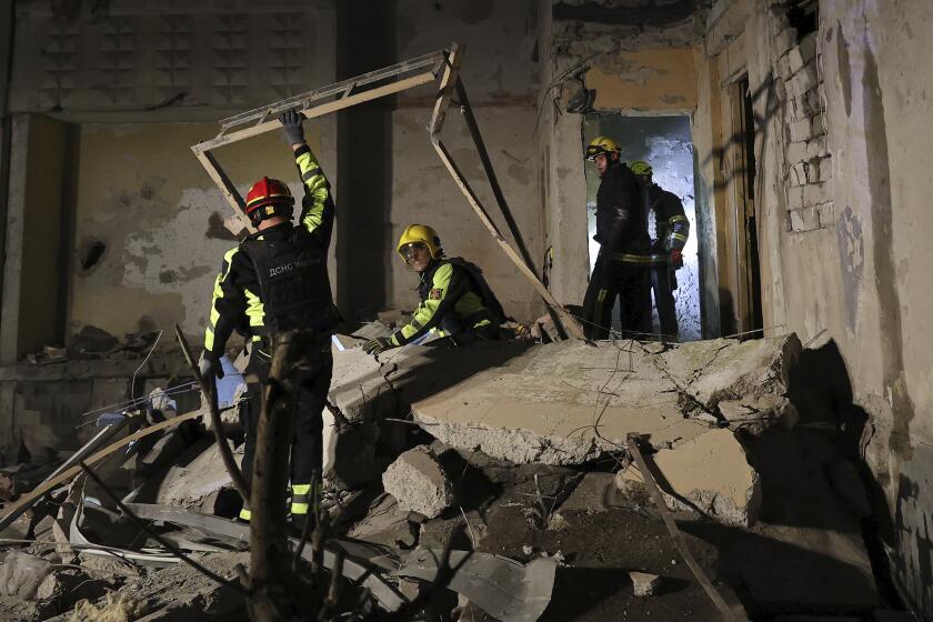 Emergency services workers move rubble after a Russian strike on a residential building in Kharkiv, Ukraine early Sunday Sept. 22, 2024. (Kharkiv Regional Military Administration via AP)