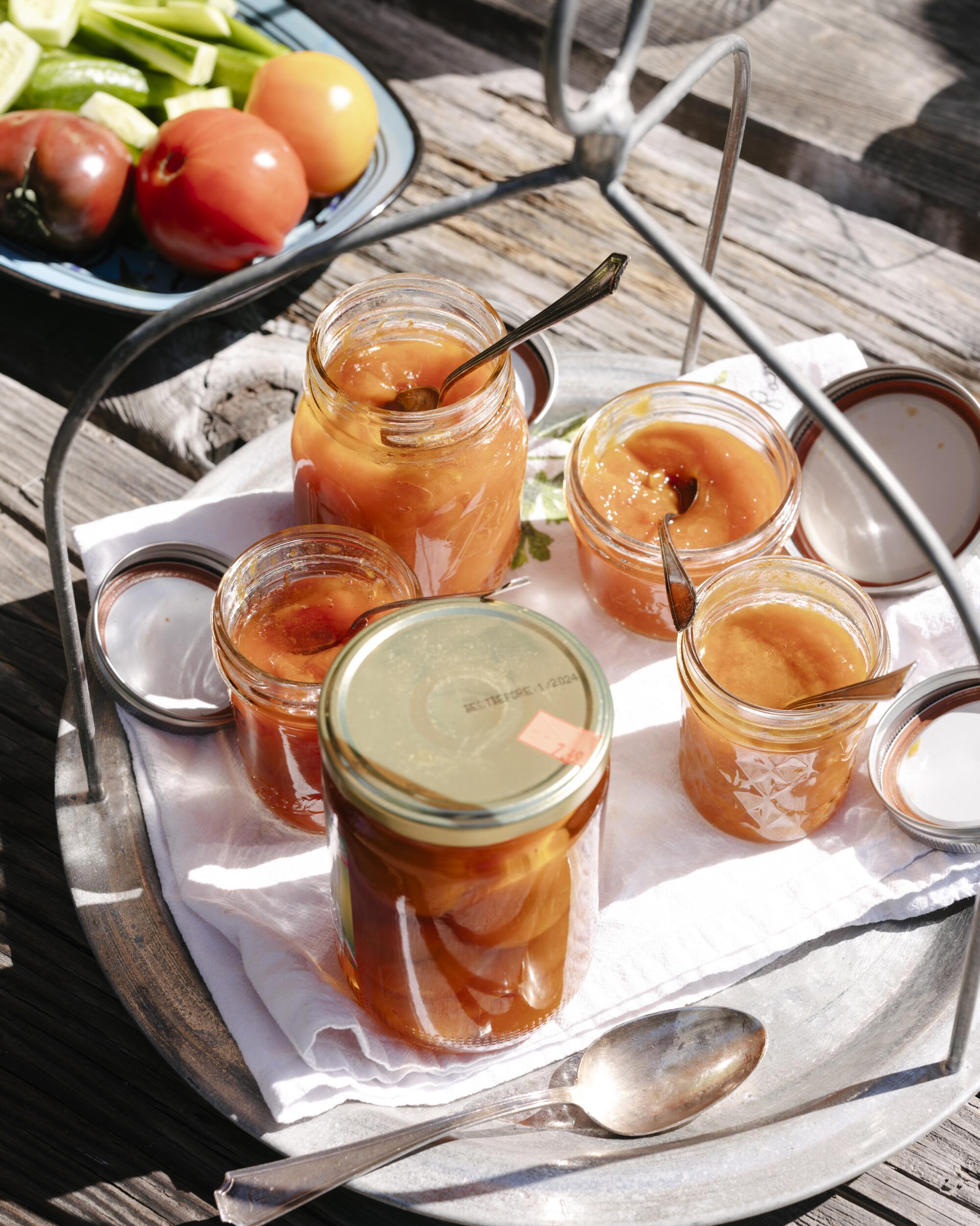 Amer Budayr's apricot jams from different batches on a table outdoors.