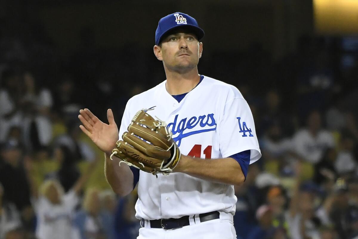 Dodgers relief pitcher Daniel Hudson reacts on the mound.