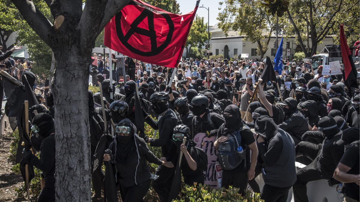Black Bloc and other Antifa protesters enter MLK Park in Berkeley on Aug. 27.