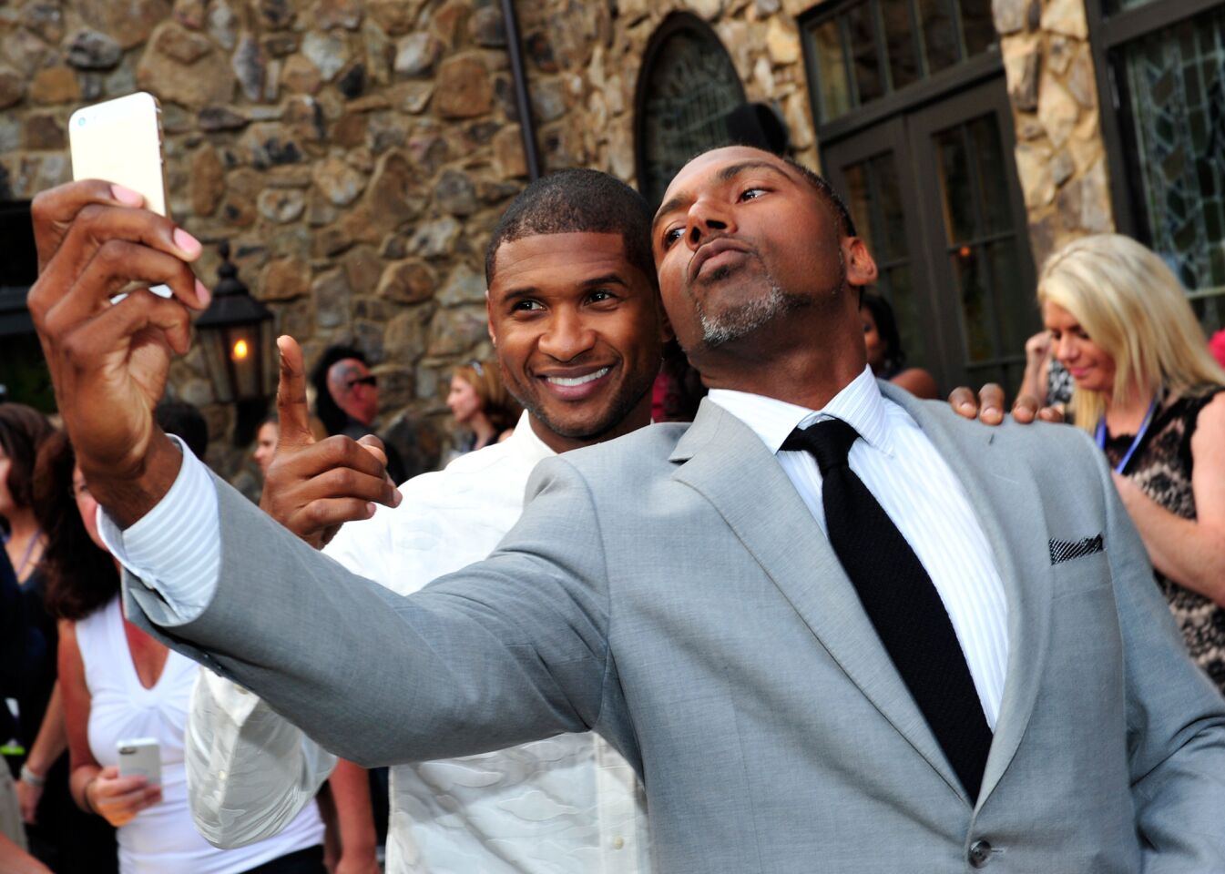 Usher and retired NFL player Allen Rossum attend the 15th anniversary Kick Off Celebration of Usher's New Look Foundation on July 30, 2014, in Atlanta.